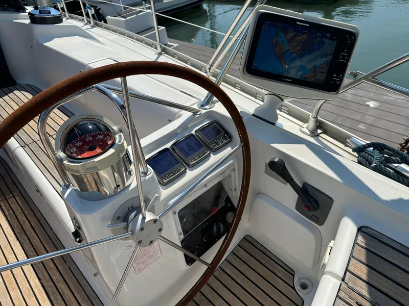 Slide: The Image of Steering wheel and navigation instruments on a 2000 Jeanneau Sun Odyssey 45.2 sailboat. - 29