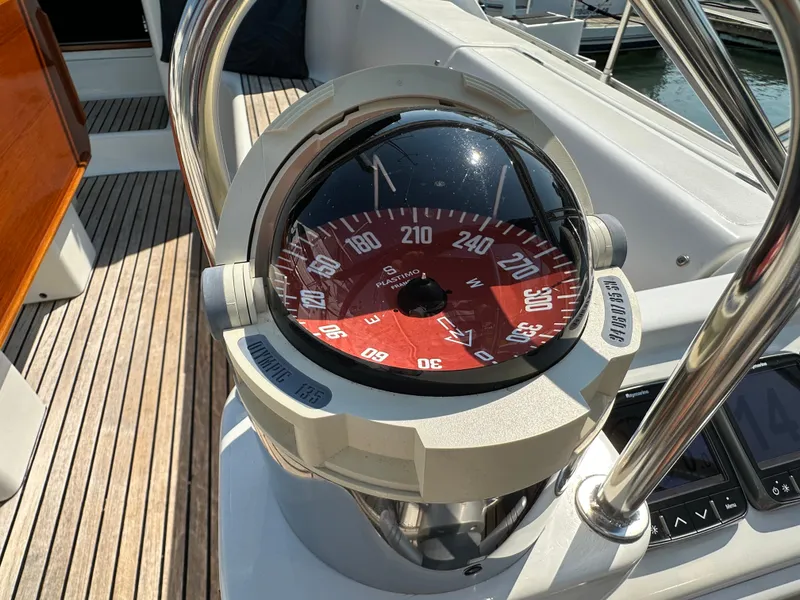 Slide: The Image of Compass on Jeanneau Sun Odyssey 45.2 yacht, 2000 model, with wooden deck background. - 33