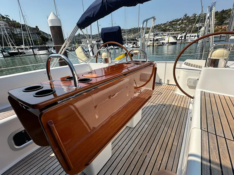 Slide: The Image of Jeanneau Sun Odyssey 45.2 yacht cockpit with polished wood table, docked in marina. - 34