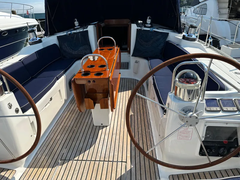 Slide: The Image of Jeanneau Sun Odyssey 45.2 yacht cockpit, featuring dual steering wheels and teak flooring, year 2000. - 36