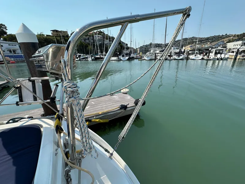 Slide: The Image of Jeanneau Sun Odyssey 45.2 sailboat docked in a marina, showcasing rigging and calm waters. - 41