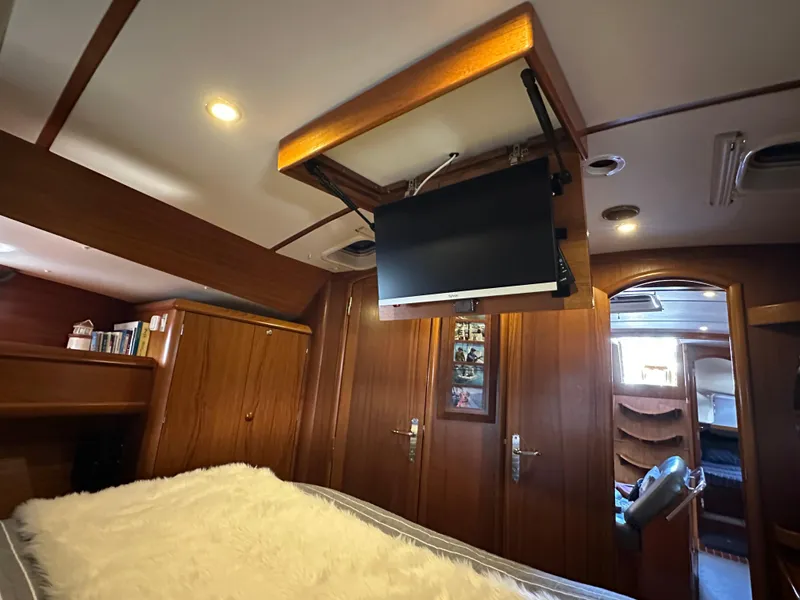 Slide: The Image of Luxurious cabin interior of 2000 Jeanneau Sun Odyssey 45.2 yacht with TV and wooden finish. - 6