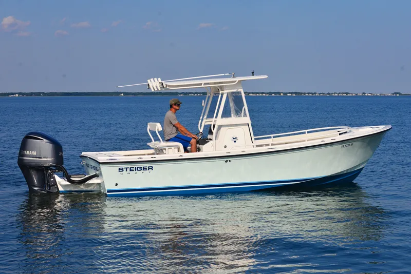 The Image of 2026 Steiger Craft 23 Tournament boat on calm blue water, side view. - 1