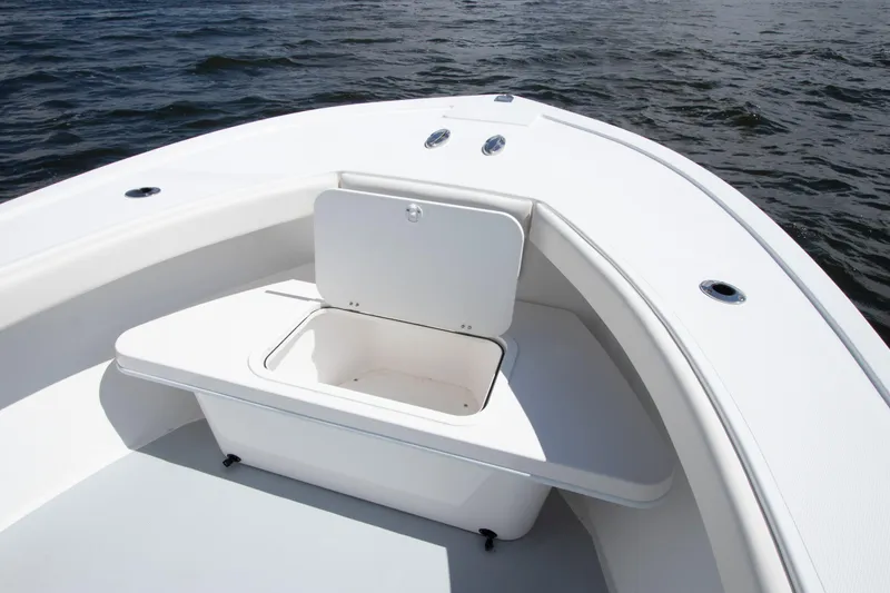 Slide: The Image of 2026 Steiger Craft 23 Tournament boat interior with open storage compartment on calm water. - 11