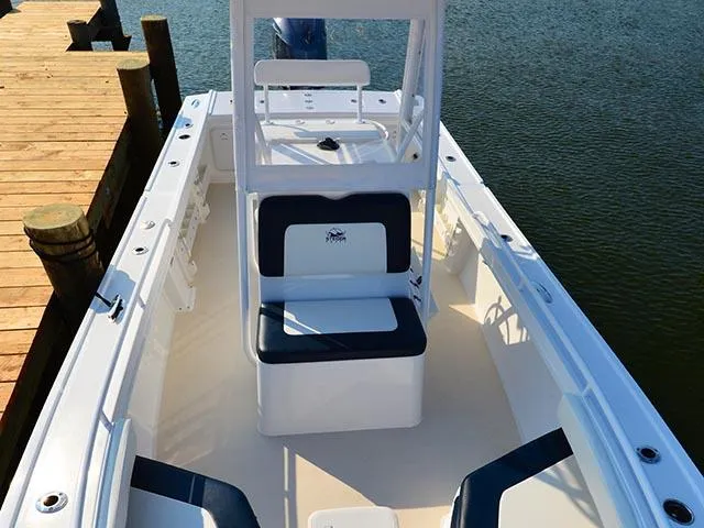 Slide: The Image of 2026 Steiger Craft 23 Tournament boat interior, docked by wooden pier, featuring seating and helm. - 8