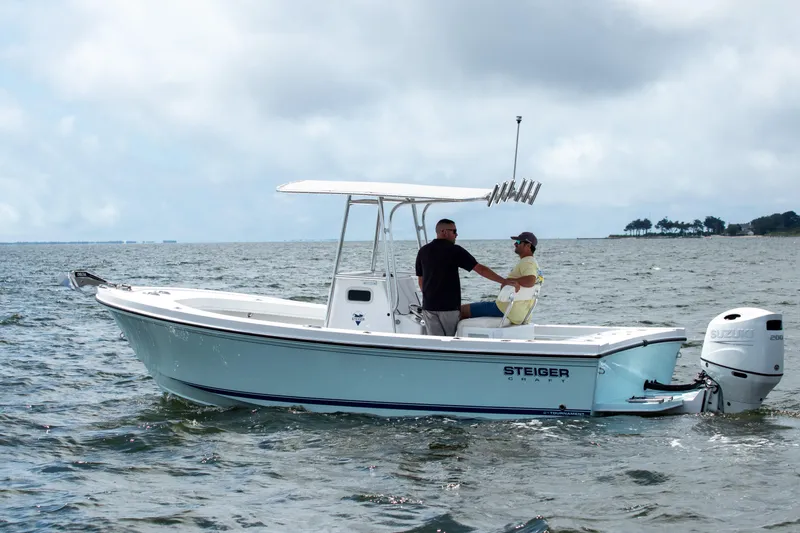 Slide: The Image of 2026 Steiger Craft 21 Tournament boat on open water, two people onboard, overcast sky. - 4