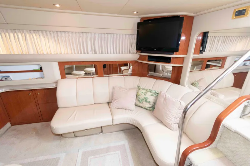 Slide: The Image of Luxurious interior of 2000 Sea Ray 420 Aft Cabin yacht with plush seating and TV. - 12