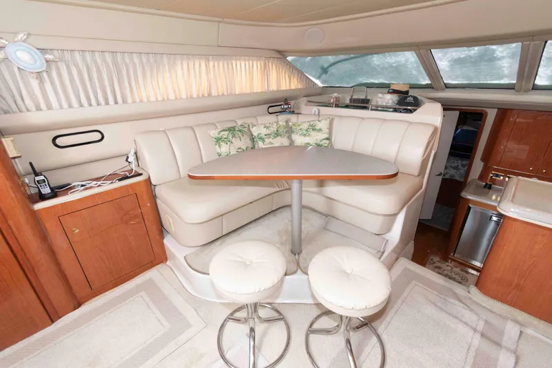 Slide: The Image of Interior of 2000 Sea Ray 420 Aft Cabin with cozy seating and dining area. - 13