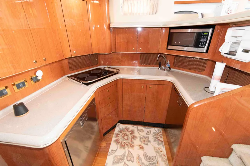 Slide: The Image of Luxurious kitchen in 2000 Sea Ray 420 Aft Cabin yacht with modern appliances. - 15