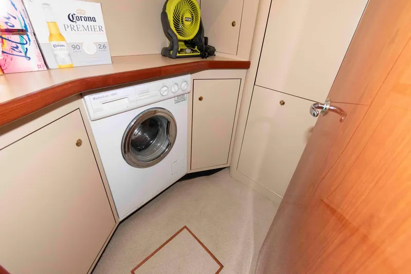 Slide: The Image of Laundry area in 2000 Sea Ray 420 Aft Cabin with washer and storage cabinets. - 16