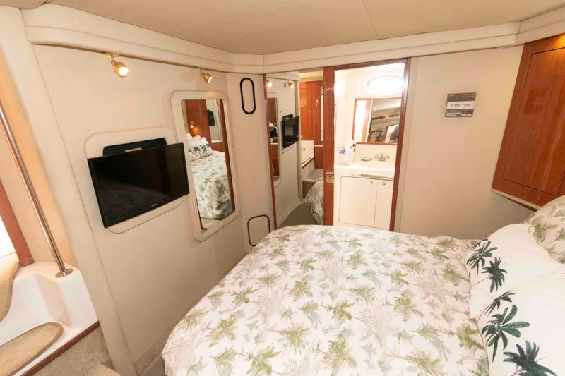 Slide: The Image of Interior of 2000 Sea Ray 420 Aft Cabin with cozy bedroom and modern amenities. - 18