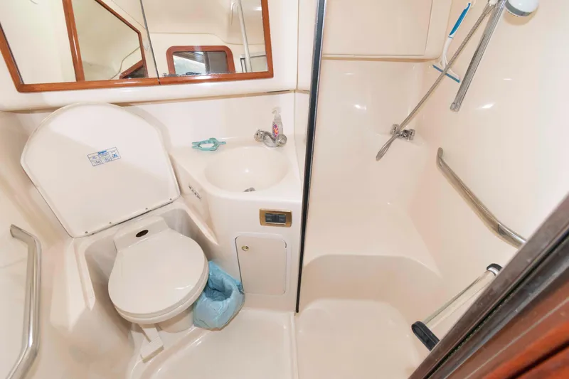 Slide: The Image of Bathroom interior of 2000 Sea Ray 420 Aft Cabin yacht, featuring toilet and shower. - 21