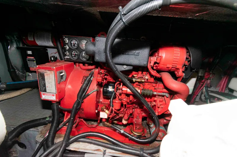 Slide: The Image of Engine room of 2000 Sea Ray 420 Aft Cabin with red generator and control panel. - 25