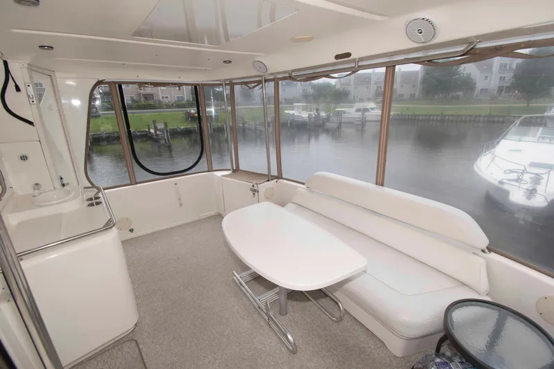 Slide: The Image of Interior of 2000 Sea Ray 420 Aft Cabin yacht with white seating and table. - 3