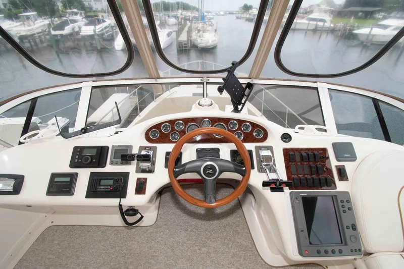 Slide: The Image of Cockpit of 2000 Sea Ray 420 Aft Cabin yacht with steering wheel and navigation controls. - 7