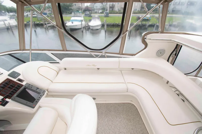 Slide: The Image of Luxurious interior of 2000 Sea Ray 420 Aft Cabin yacht with plush seating and navigation equipment. - 9