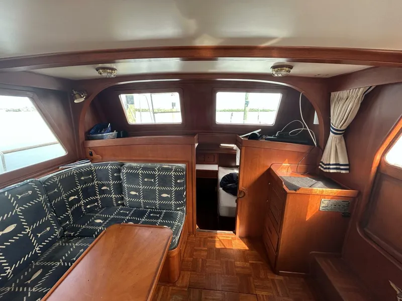 Slide: The Image of 1978 Albin 36 Trawler interior with wood finish and patterned seating. - 13