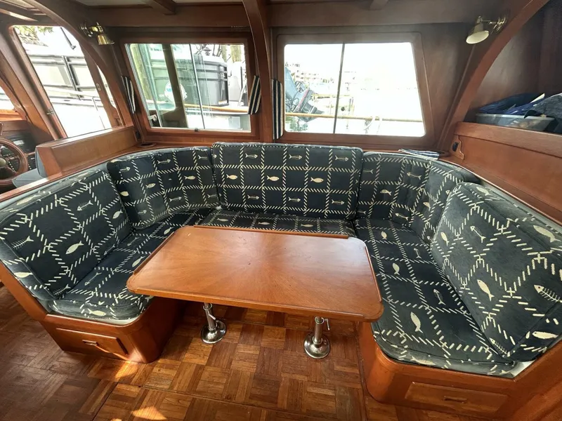 Slide: The Image of Interior of 1978 Albin 36 Trawler with patterned seating and wooden table. - 16