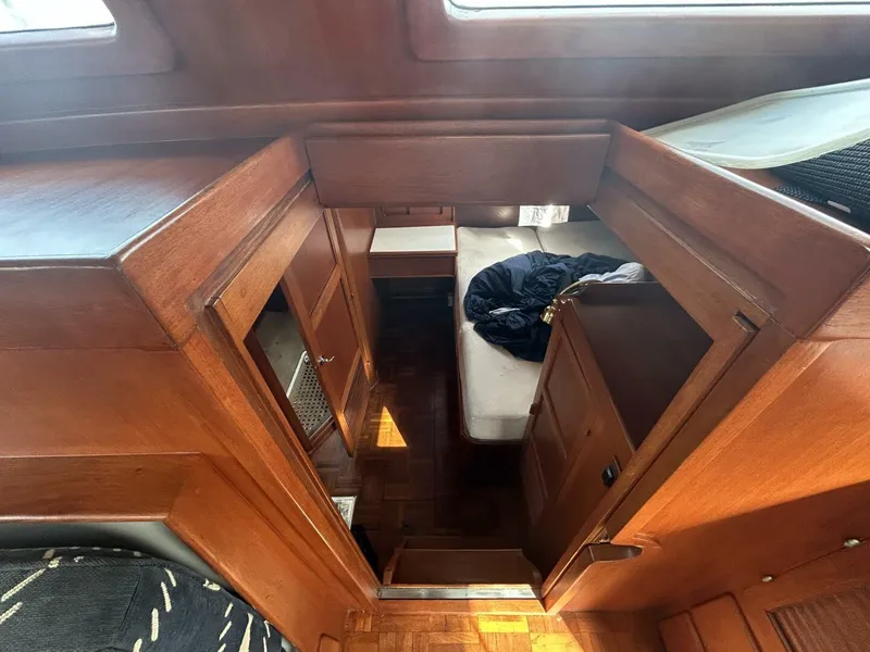Slide: The Image of Interior view of 1978 Albin 36 Trawler, featuring wooden cabinetry and cozy sleeping area. - 21