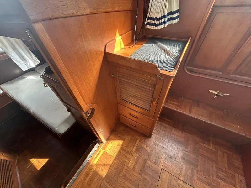 Slide: The Image of 1978 Albin 36 Trawler interior with wooden cabinetry and parquet flooring. - 24