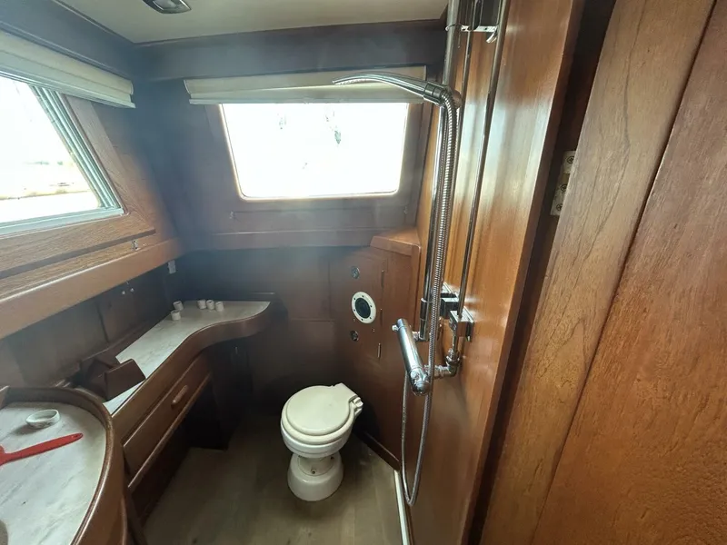 Slide: The Image of 1978 Albin 36 Trawler bathroom with wooden interior and shower. - 26