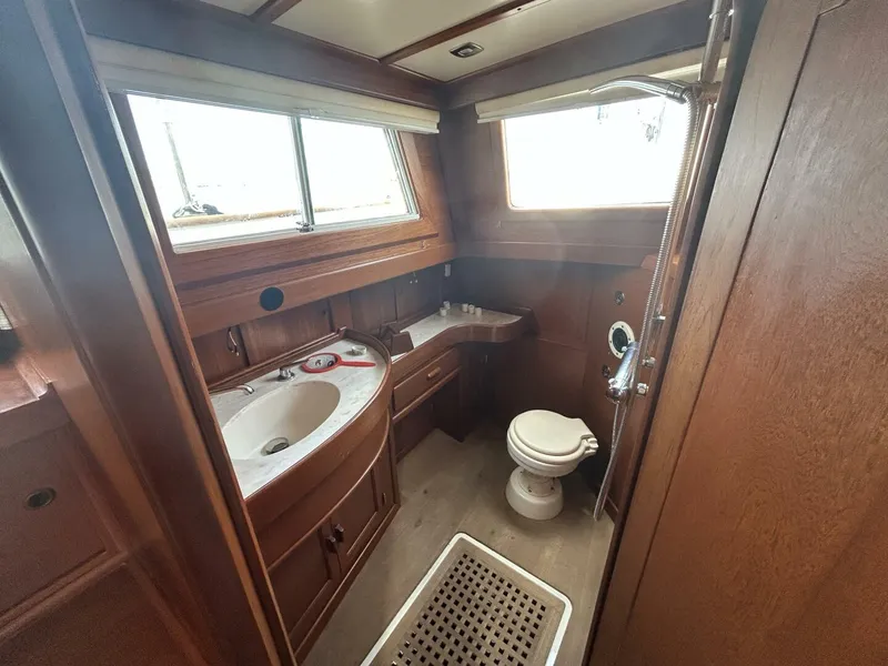 Slide: The Image of 1978 Albin 36 Trawler bathroom with wooden interior, sink, and toilet. - 27