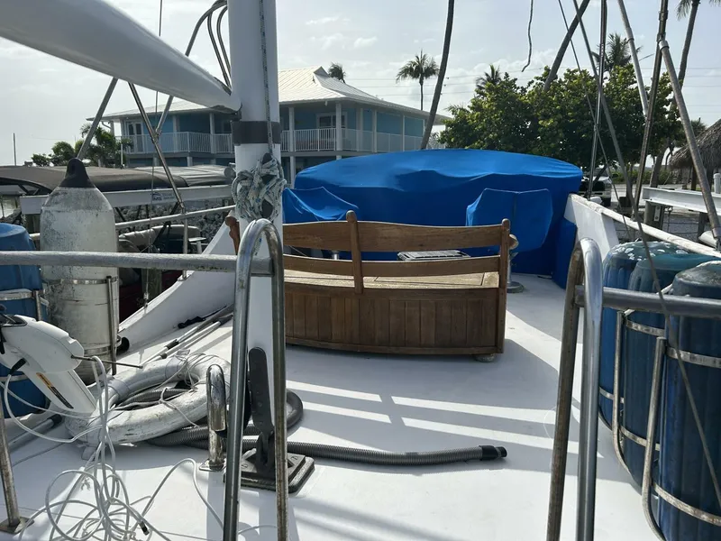 Slide: The Image of 1978 Albin 36 Trawler deck with wooden bench and blue cover. - 36