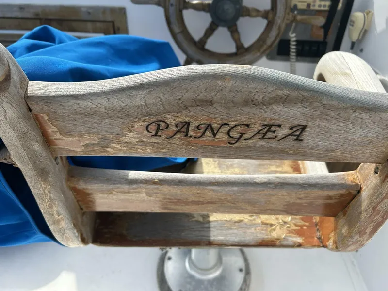 Slide: The Image of Wooden helm seat on 1978 Albin 36 Trawler, engraved with "Pangaea." - 40