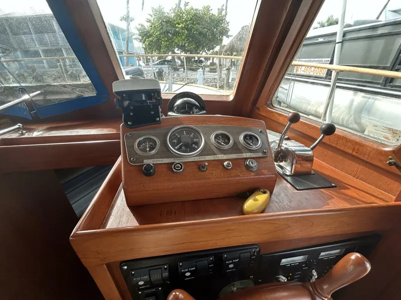 Slide: The Image of 1978 Albin 36 Trawler helm with classic wooden dashboard and navigation instruments. - 6