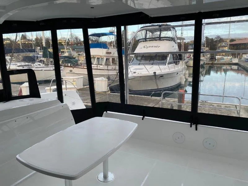 Slide: The Image of Interior view of 2024 Lagoon 42 catamaran with marina backdrop. - 29