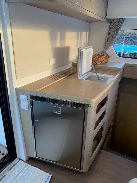 Slide: The Image of Modern kitchen area in 2024 Lagoon 42 catamaran with stainless steel fridge and sink. - 4
