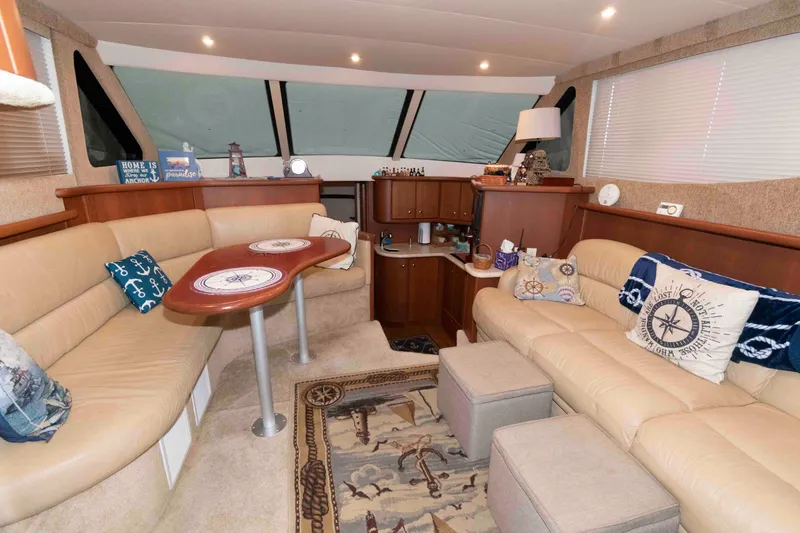 Slide: The Image of Luxurious interior of 2005 Silverton 34 Convertible yacht with beige seating and nautical decor. - 11