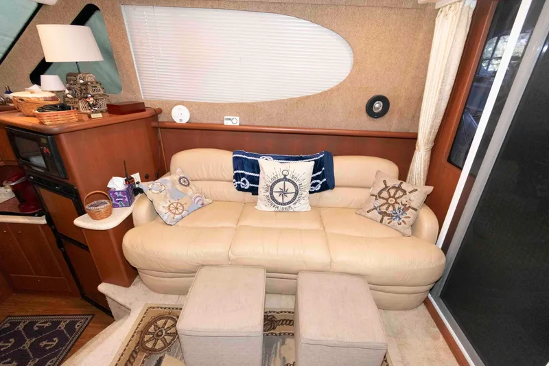 Slide: The Image of Interior of 2005 Silverton 34 Convertible yacht with beige sofa and nautical-themed decor. - 12