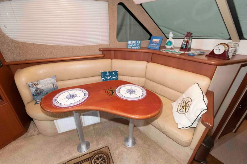 Slide: The Image of Interior of 2005 Silverton 34 Convertible yacht with cozy seating and nautical decor. - 13
