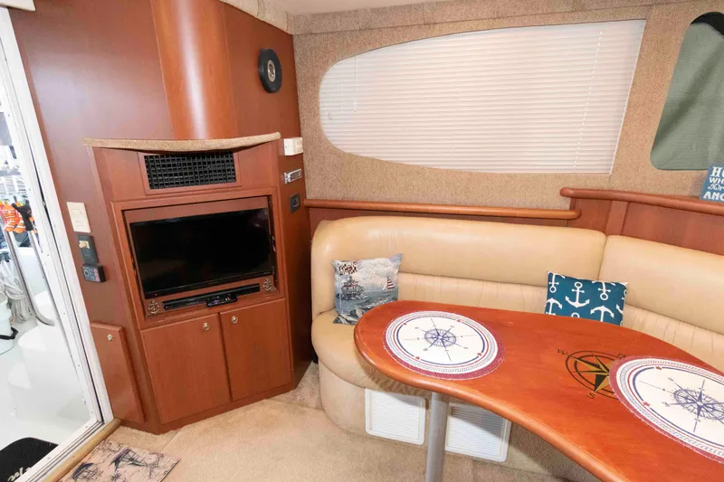 Slide: The Image of Interior of 2005 Silverton 34 Convertible yacht with cozy seating and nautical decor. - 14