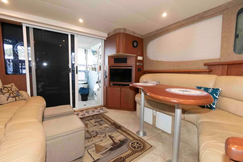 Slide: The Image of Interior of 2005 Silverton 34 Convertible yacht with cozy seating and dining area. - 15