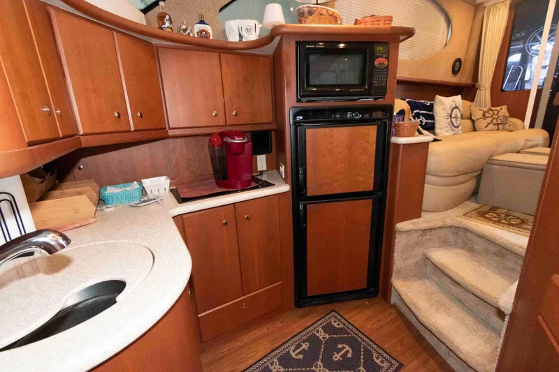 Slide: The Image of 2005 Silverton 34 Convertible yacht interior with kitchen and cozy seating area. - 16