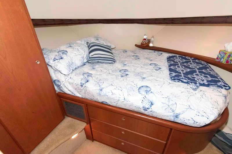Slide: The Image of Cozy bedroom in 2005 Silverton 34 Convertible yacht with nautical-themed bedding. - 17