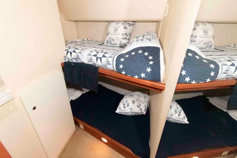 Slide: The Image of Bunk beds in 2005 Silverton 34 Convertible yacht cabin with nautical-themed bedding. - 18