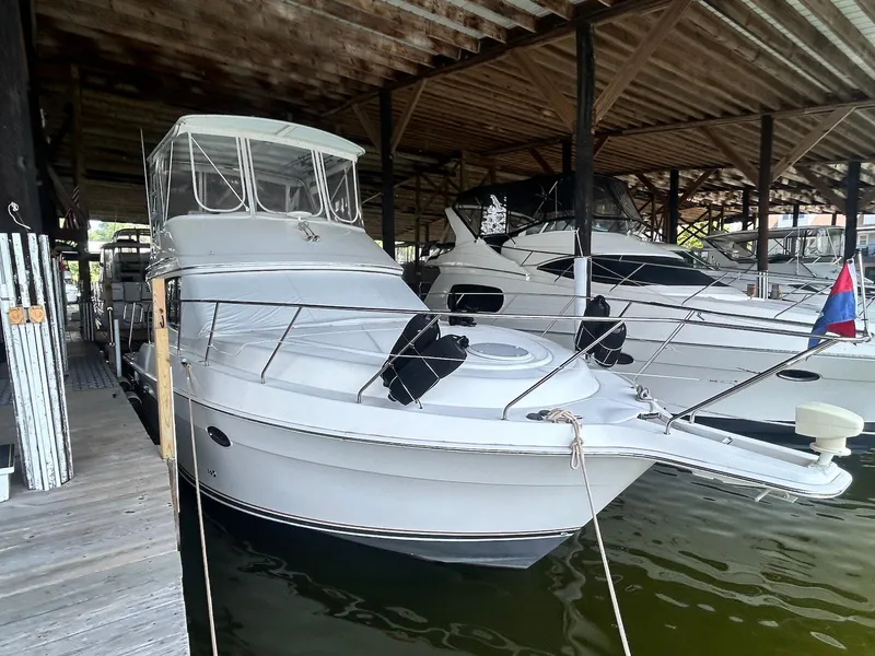 Slide: The Image of 2005 Silverton 34 Convertible yacht docked in a covered marina. - 3