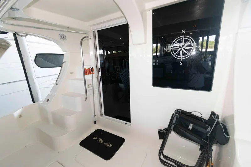 Slide: The Image of 2005 Silverton 34 Convertible yacht interior with compass design and folding chair. - 4