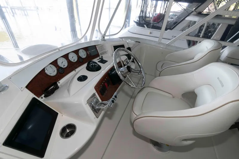 Slide: The Image of 2005 Silverton 34 Convertible yacht helm with steering wheel and gauges. - 5
