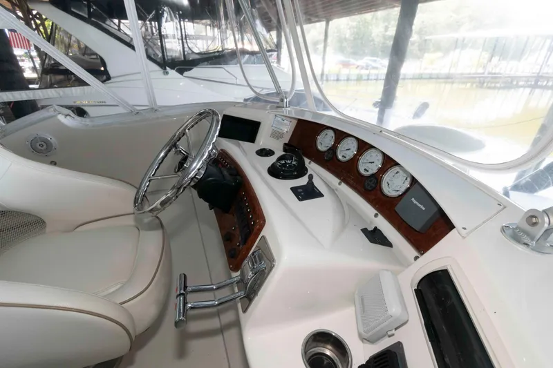 Slide: The Image of 2005 Silverton 34 Convertible boat helm with gauges and steering wheel. - 6