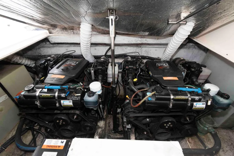 Slide: The Image of Engine compartment of a 2004 Rinker Fiesta Vee 342 boat, featuring dual inboard motors. - 16