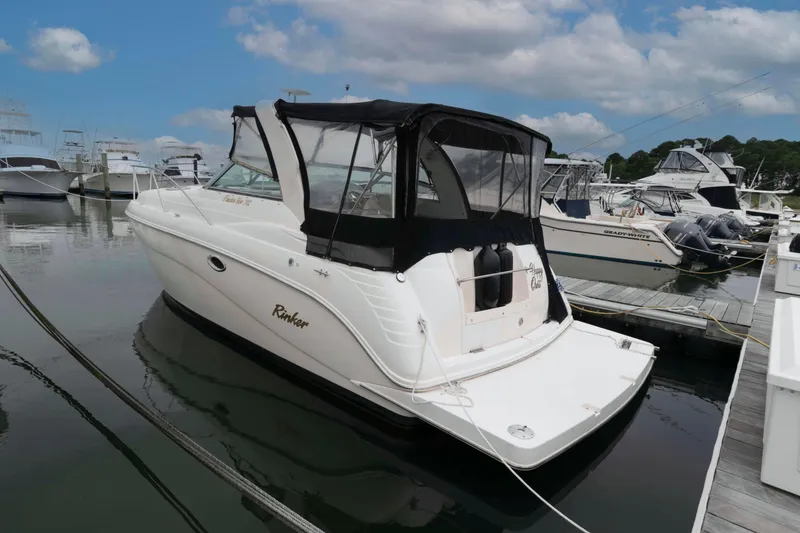 Slide: The Image of 2004 Rinker Fiesta Vee 342 boat docked at marina under cloudy sky. - 2