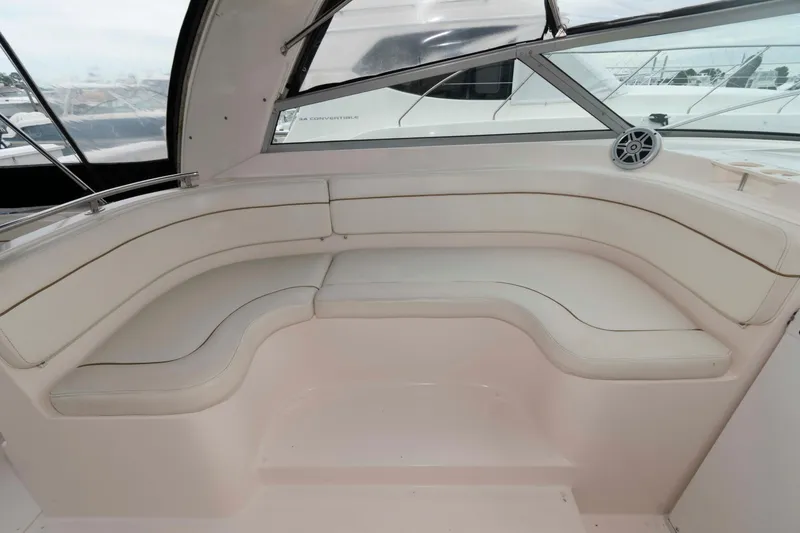 Slide: The Image of 2004 Rinker Fiesta Vee 342 boat interior with white cushioned seating. - 9