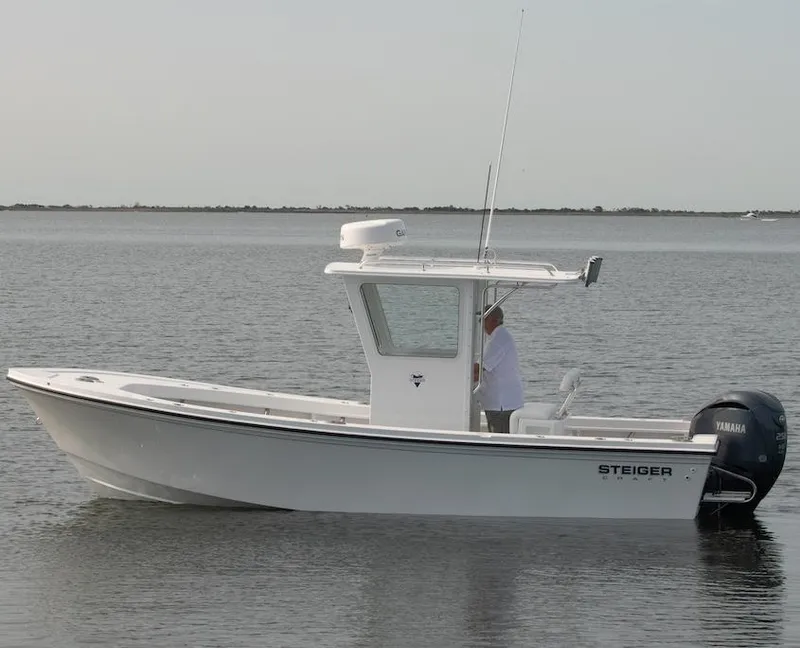 The Image of 2026 Steiger Craft 23 Chatham boat on calm water, side view. - 1