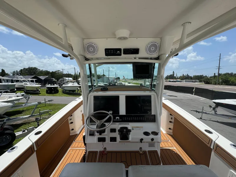 Slide: The Image of 2019 World Cat 3200 boat cockpit with steering wheel and control panel. - 11