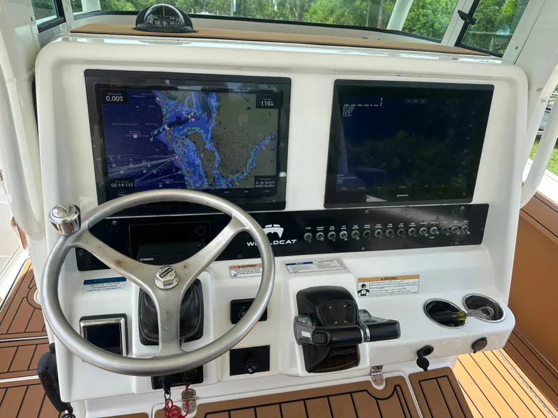 Slide: The Image of 2019 World Cat 3200 helm with dual navigation screens and steering wheel. - 12