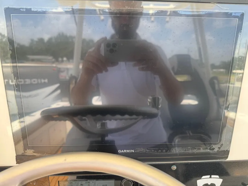 Slide: The Image of Reflection on Garmin screen in 2019 World Cat 3200 boat cockpit. - 14